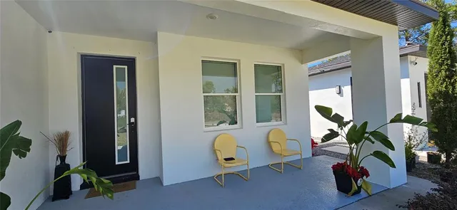 a front view of a house with outdoor seating