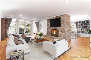 a living room with fireplace furniture and a flat screen tv