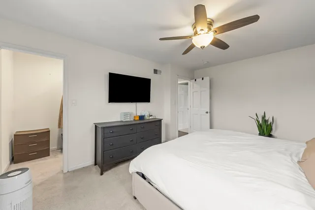 a bedroom with a bed window and a flat screen tv