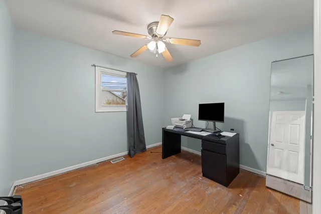 a workspace with wooden floor and a window