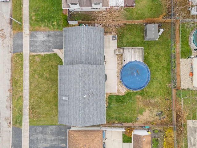 an aerial view of residential house with outdoor space and parking
