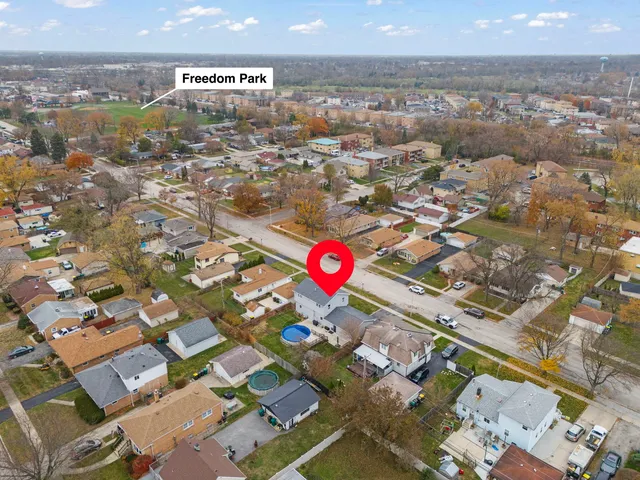an aerial view of residential building with parking