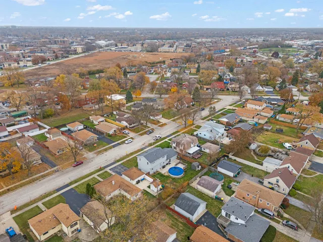 an aerial view of residential houses with outdoor space
