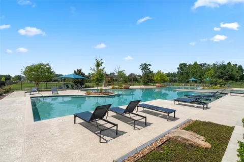 an aerial view of a house with a yard and lake view