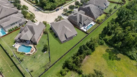 an aerial view of a house with a garden and swimming pool