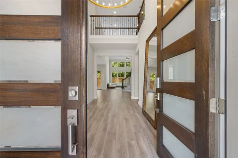a view of hallway with wooden floor
