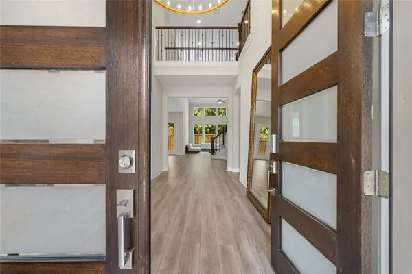 a view of hallway with wooden floor