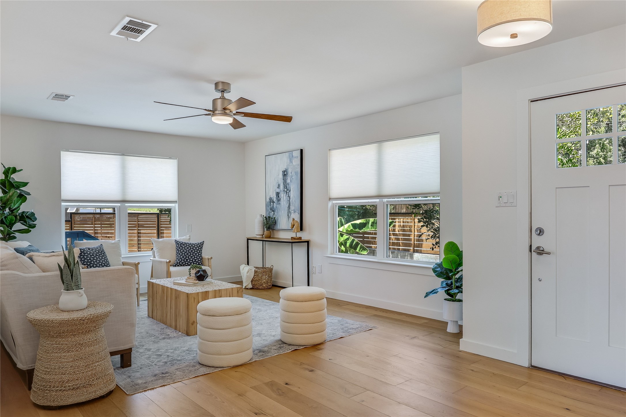 5203 Ledesma Road Austin, TX 78721 - Photo 4 of 40 Step into a sun-filled living space featuring natural wood flooring and ample natural light.