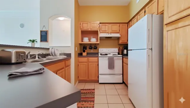 a kitchen with white cabinets and white appliances