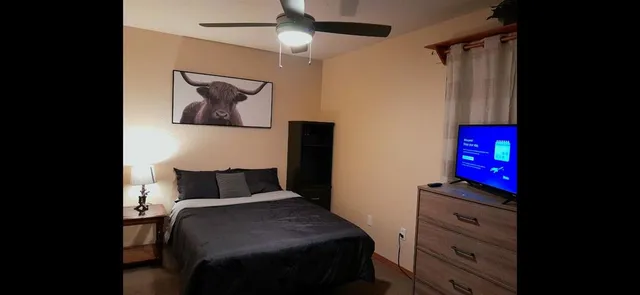 a bedroom with a bed and a painting on the wall