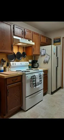 a kitchen with stainless steel appliances granite countertop a stove and a sink