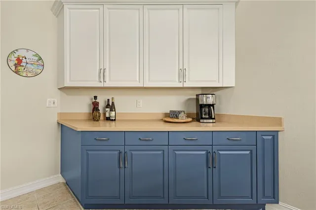 a kitchen with granite countertop white cabinets and sink