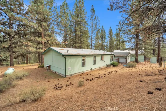 a view of a house with a yard covered in snow
