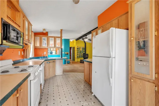 a kitchen with stainless steel appliances a refrigerator sink and cabinets
