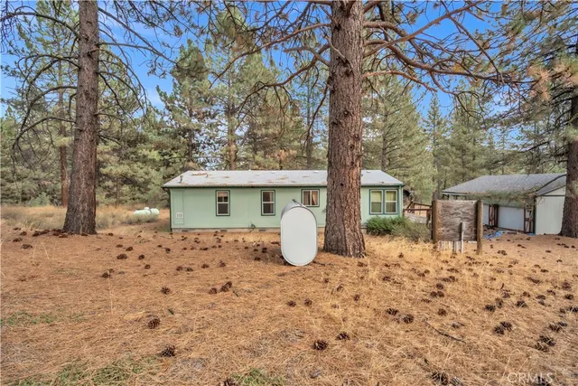 a view of a house with large trees