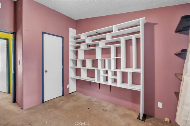 an aerial view of a house with pool and garden