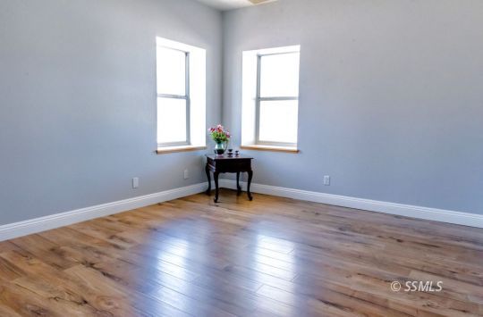 1652 Rademacher Way Ridgecrest, CA 93555 - Photo 10 of 16 a view of an empty room with wooden floor and a window