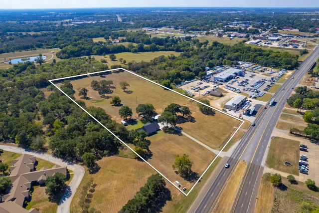 an aerial view of a residential houses with outdoor space