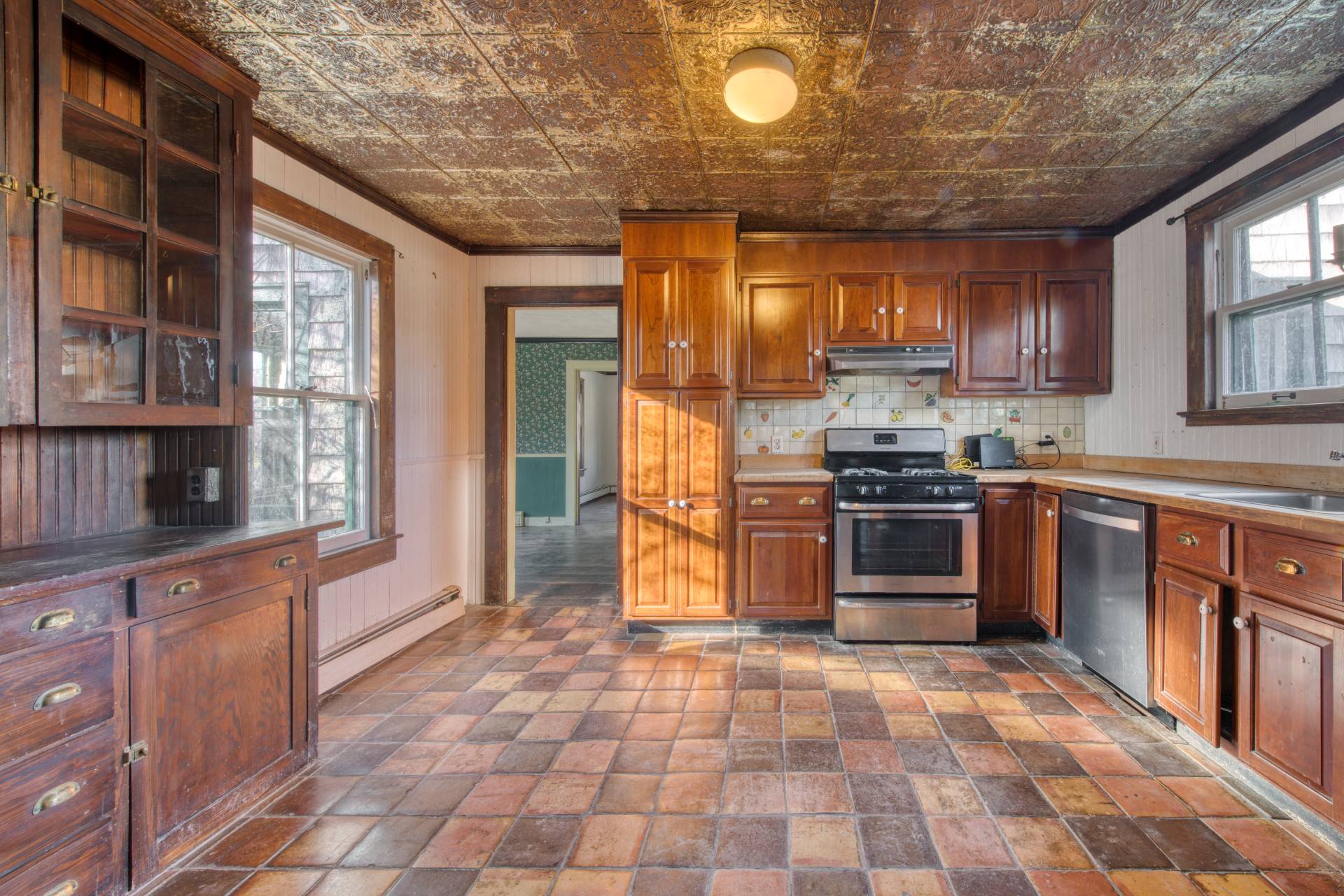 438 Main Street Amagansett, NY 11930 - Photo 6 of 10 a kitchen with stainless steel appliances granite countertop a stove a sink and a refrigerator