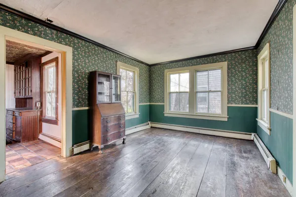 wooden floor in an empty room with a fireplace