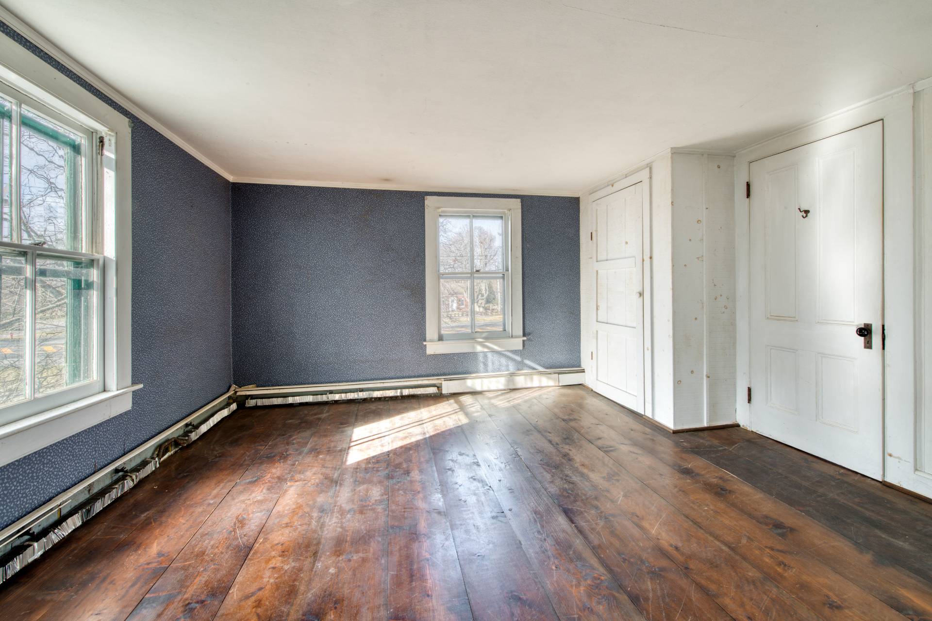 438 Main Street Amagansett, NY 11930 - Photo 8 of 10 an empty room with wooden floor and windows