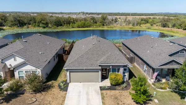 an aerial view of a house with garden space and outdoor seating