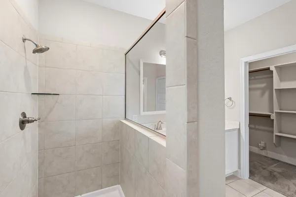 a bathroom with a double vanity sink and a mirror