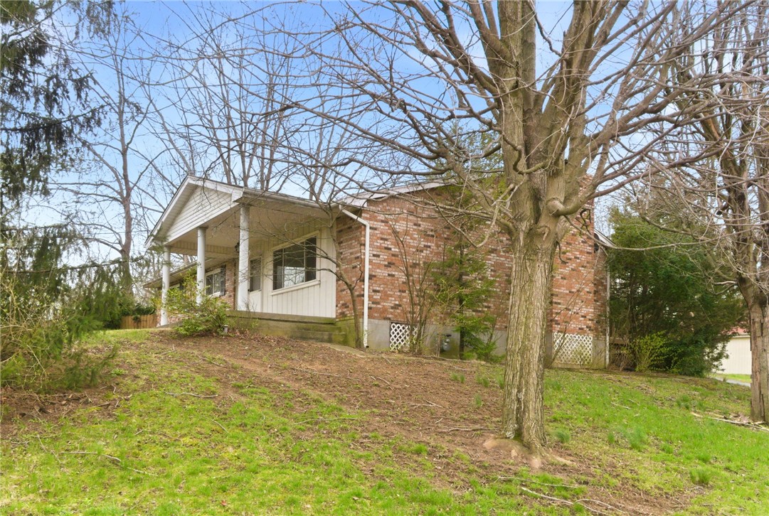 6711 Hamilton-Middletown Road Franklin, OH 45005 - Photo 3 of 49 This brick home features a covered porch, set among mature trees and a grassy yard.
