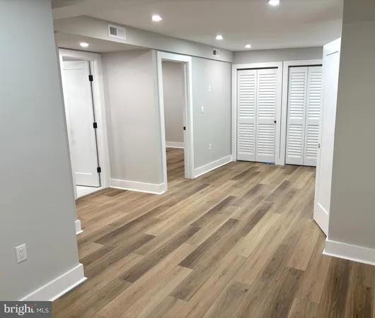 an empty room with wooden floor