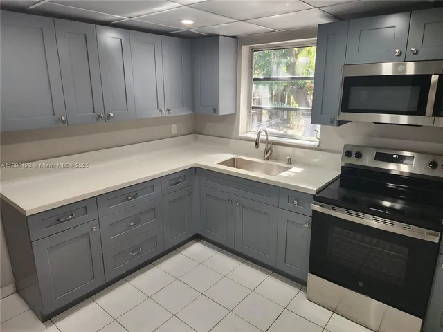 a kitchen with a sink and cabinets