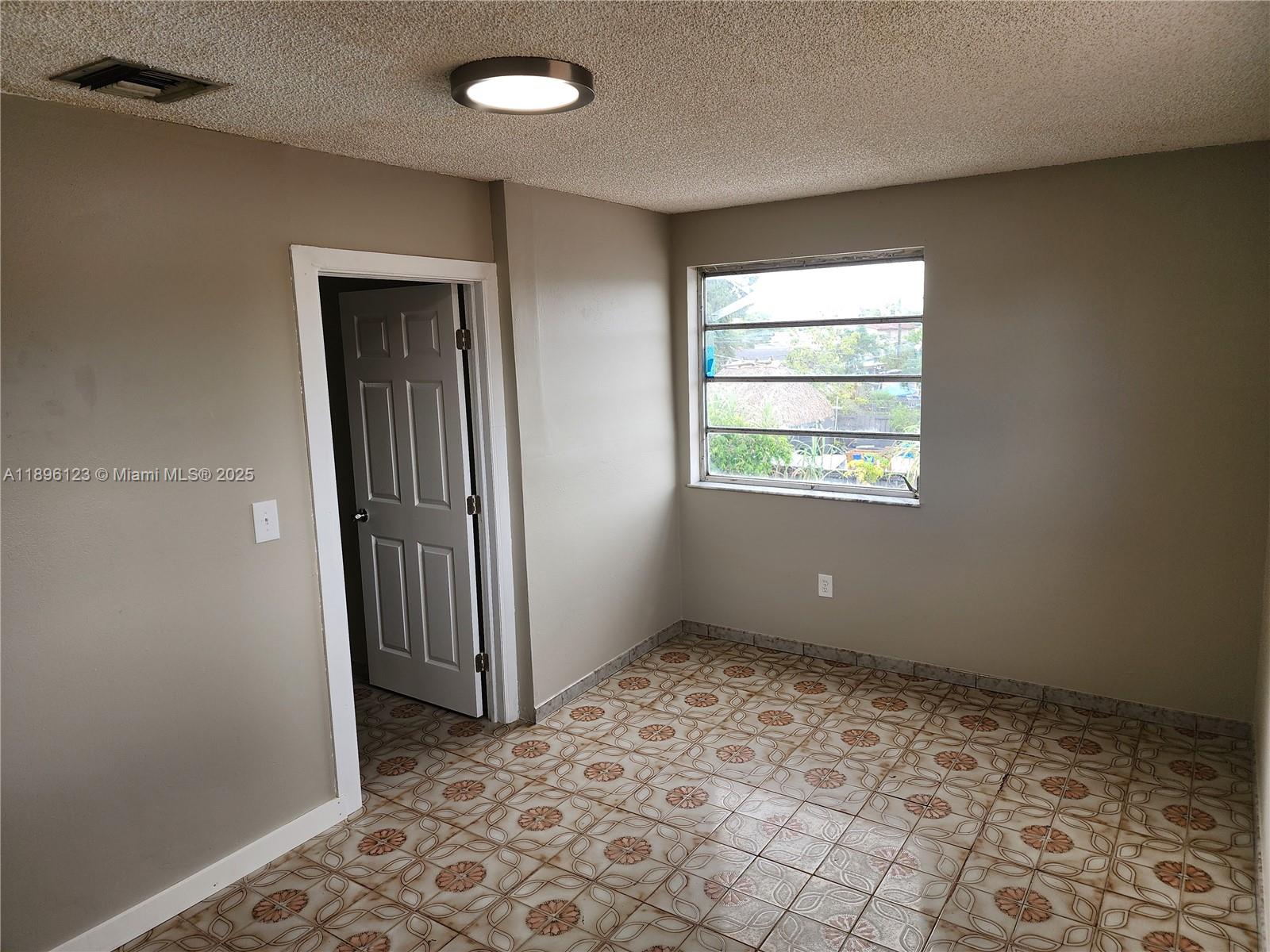 74 East 17th Street, Unit 70 Hialeah, FL 33010 - Photo 26 of 38 an empty room with windows