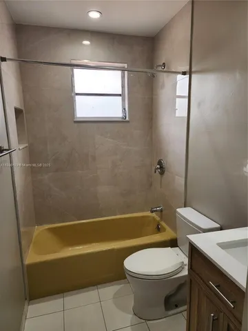 a view of a bedroom with wooden floor and bathroom