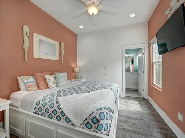 a bedroom with a large bed and a chandelier
