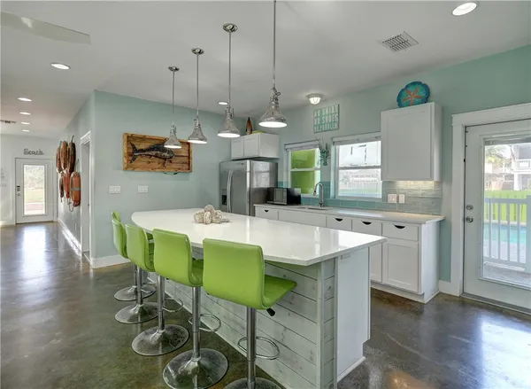 a large kitchen with a table and chairs