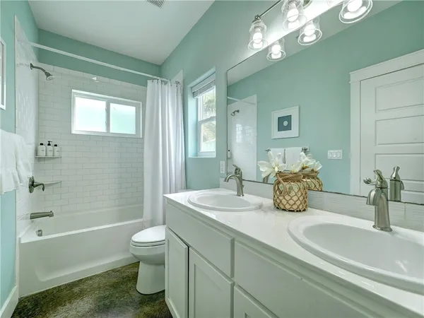 a bath room with a toilet a sink and a bath tub