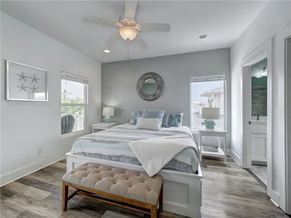 a bedroom with a bed and wooden floor
