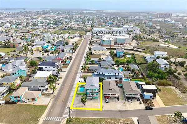 an aerial view of residential houses with outdoor space and swimming pool