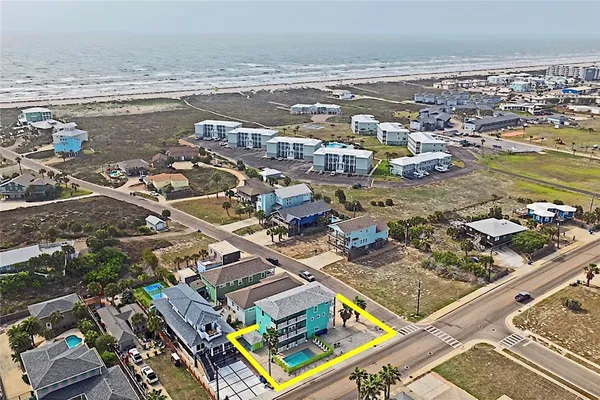 an aerial view of residential building and lake
