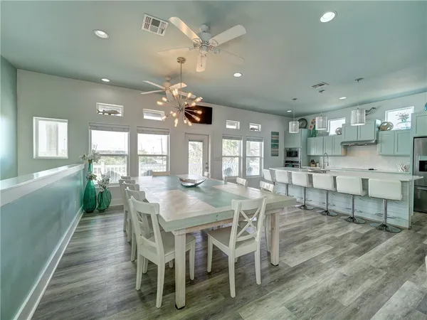 a view of a dining room with furniture and wooden floor