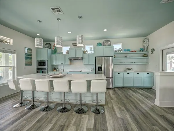 a large kitchen with a table and chairs in it