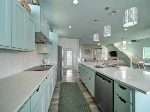 a kitchen with sink stove and cabinets