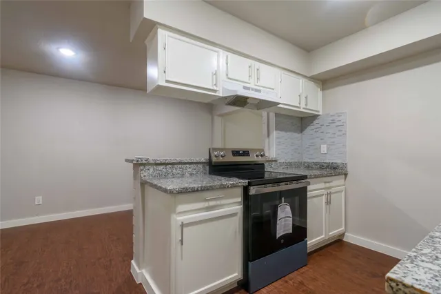a kitchen with stainless steel appliances granite countertop a stove and a sink