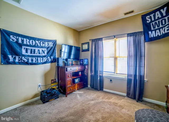 a view of an empty room with window and closet