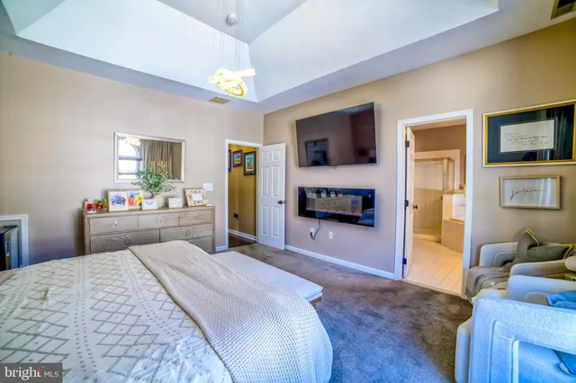 a bedroom with a bed and a television