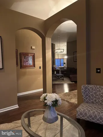 a living room with furniture and floor to ceiling window