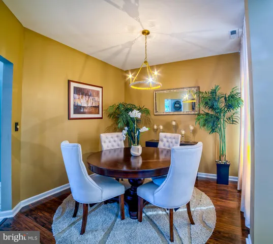a view of a dining room with furniture and a potted plant