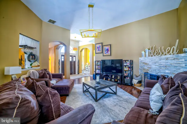 a living room with furniture and a fireplace