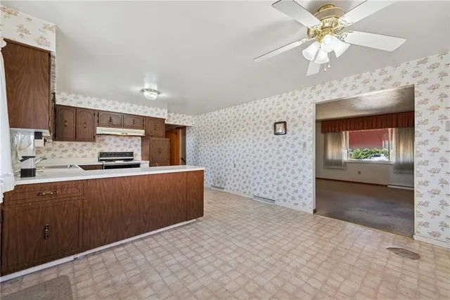 a kitchen with stainless steel appliances a refrigerator and a stove top oven