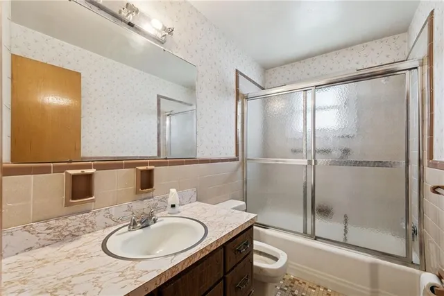 a bathroom with a sink toilet and shower