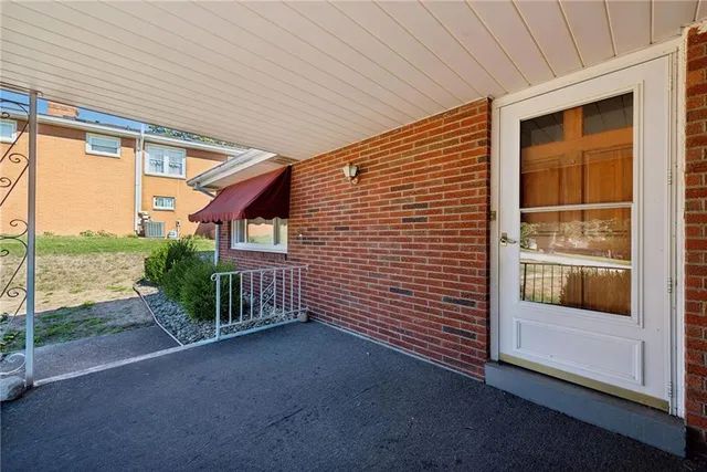 a view of a porch with furniture and floor to ceiling window